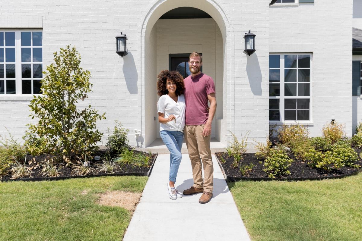 Couple in front of house